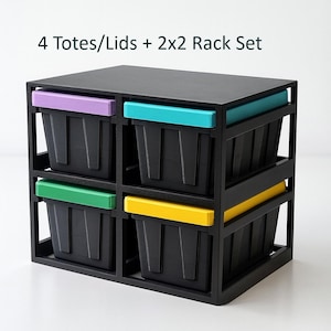 May include: A black storage rack set with four black totes, each with a colored lid. The lids are purple, teal, green, and yellow. The text "4 Totes/Lids + 2x2 Rack Set" is printed on the top.