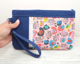 Pochette zippée We Rise by Lifting Others avec dragonne amovible S745