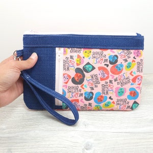 We Rise By Lifting Others Zippy Clutch with detachable Wristlet Strap