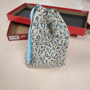 Scrabble word tile drawstring storage bag.