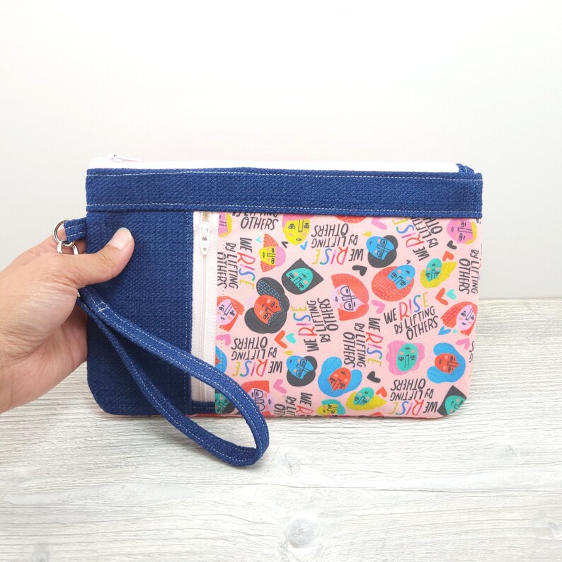 We Rise By Lifting Others Zippy Clutch with detachable Wristlet Strap