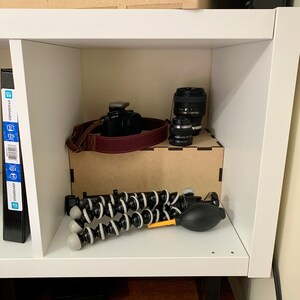 cube shelf riser displaying camera accessories
