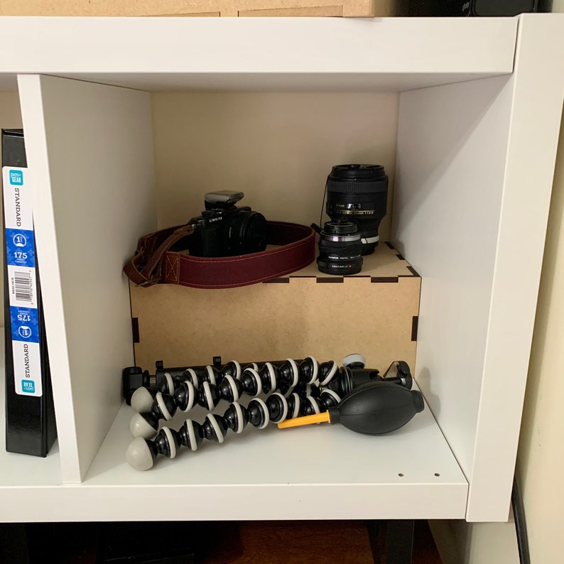 cube shelf riser displaying camera accessories