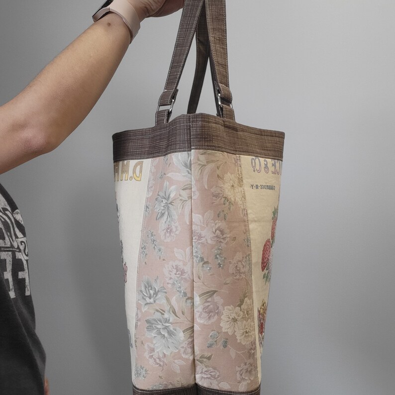 Side of the vintage flower seed tote bag with floral print and brown accents.