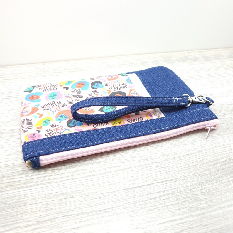 We Rise By Lifting Others Zippy Clutch with detachable Wristlet Strap