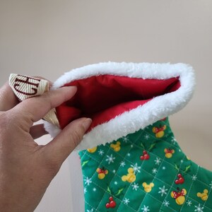 Quilted disney holiday stockings with red interior.