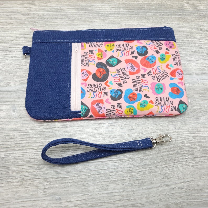 We Rise By Lifting Others Zippy Clutch with detachable Wristlet Strap