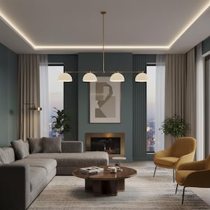 May include: A linear chandelier featuring four white dome-shaped shades suspended from a thin brass-colored metal rod. The fixture is positioned horizontally, providing downward illumination with its four evenly spaced light sources.