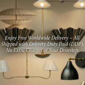 May include: A collection of wall-mounted and hanging light fixtures featuring various designs, including pleated shades, conical metal shades, and brass-toned arms. The lighting fixtures are arranged in a group, showcasing different shapes and finishes.