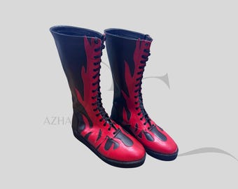 May include: A pair of tall, black and red boots with a flame design. The boots have a lace-up front and a flat sole. The red flames are outlined in black. The boots are made of leather.