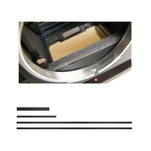 May include: Close-up of a camera's interior, showcasing a black foam light seal and metallic components. The image highlights the internal structure, with a focus on the light-sealing mechanism and the camera's design.