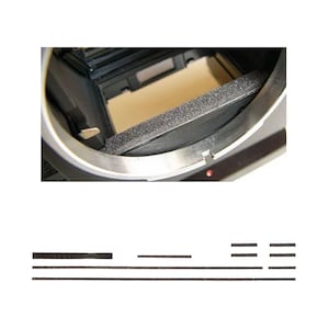 May include: A close-up of a camera interior featuring a black foam light seal and a silver metal frame. Below are several black foam light seal strips of varying lengths, likely for camera repair or replacement.