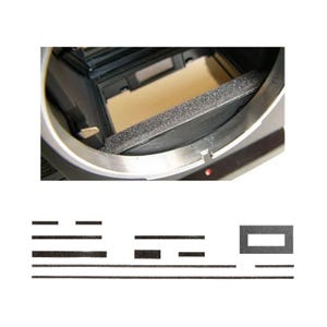 May include: A close-up of a camera interior with a black foam light seal and a set of replacement light seals. The camera body is silver and black, with a tan interior. The light seals are black and come in various shapes and sizes.