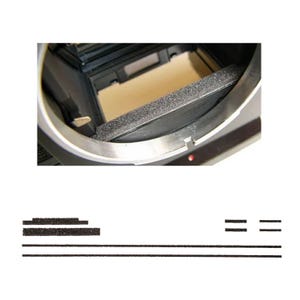 May include: A close-up of a camera interior with a black foam light seal and a silver metal frame. Additional black foam strips are below the camera body.