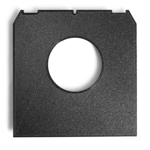 May include: A square, black, textured object with a large, circular hole in the center. The object has a beveled edge and two small notches at the top. The surface has a diagonal pattern.