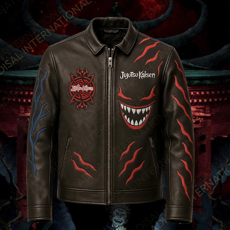 May include: A brown leather jacket with a zip fastening and a collared neckline. The jacket features embroidered designs in red and blue, including the text "Jujutsu Kaisen" and a stylized monster face. The jacket has a classic biker style.