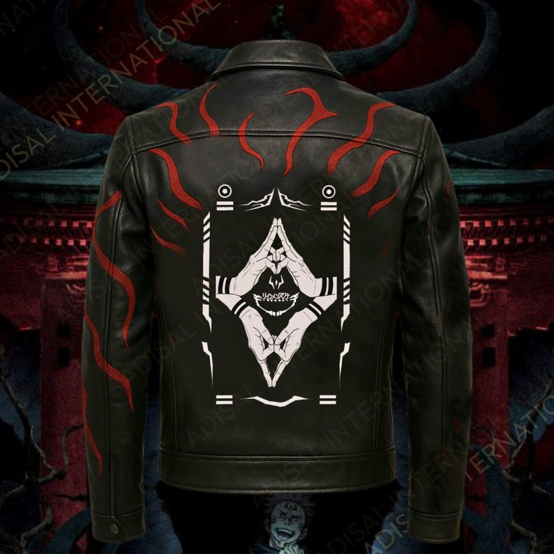 May include: Black leather jacket with red flame-like designs on the shoulders and back. The back features a white graphic of hands in a prayer position with a skull and geometric shapes. A classic collared jacket.