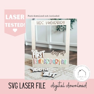 May include: A wooden photo frame with the text "MRS. VANDERBERG" at the top. Below, the words "my FIRST day of Kindergarten" are displayed in colorful, 3D lettering. Additional text includes "TOOM LIST" and "SVG LASER FILE digital download."