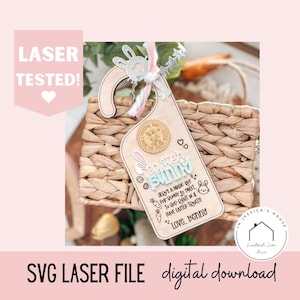 May include: Wooden Easter Bunny door hanger with a bunny-shaped top and text that reads "Easter Bunny." The design includes a bunny, carrots, and the words "Here's a magic key for bunny so sweet." The words "Laser Tested" are also visible.