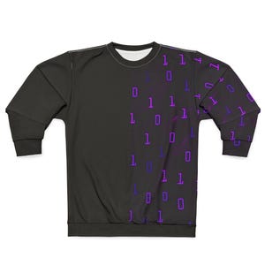 May include: Black sweatshirt featuring a binary code pattern. The left side is plain black, and the right side and sleeves display purple and blue binary digits. The long-sleeved crew neck top is visible.