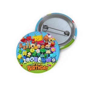 May include: Two round pinback buttons. One button shows a collection of cartoon characters with smiling faces on a blue background. The text "IT'S MY BIRTHDAY" is at the bottom. The other button is silver with a pin.