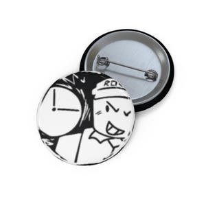 May include: A black and white button badge featuring a cartoon character with a clock and the text "RO". The badge has a metal backing and a safety pin closure. The design is a graphic illustration.