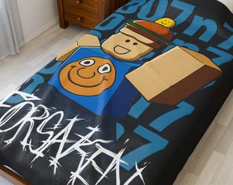 May include: Black and blue bedspread with a cartoon character design. The design features a smiling face, a figure with a burger hat, and the word "FORSAKEN" in white graffiti-style lettering. Blue numbers are scattered across the background.