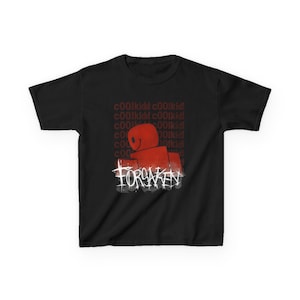 May include: Black t-shirt featuring a red graphic of a smiling block figure with the word "FORSAKEN" in white. The text "c00lkidd" is repeated in a pattern above the figure.