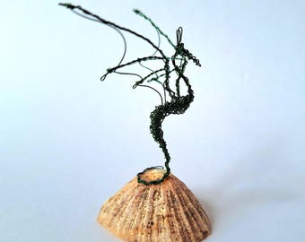 Single small dragon or amphiptere on a natural mount sketched in 3D in recycled red wire