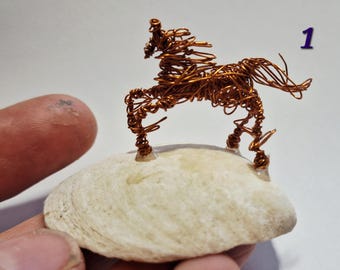 Tiny horse on a shell sketched in 3D in recycled copper wire