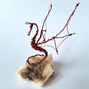 Single small dragon or amphiptere on a natural mount sketched in 3D in recycled red wire