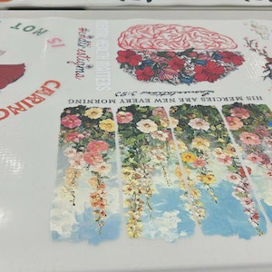 May include: A white surface with Disney character graphics and text. The design includes Mickey Mouse, Donald Duck, and Goofy. Other sections feature floral and brain illustrations with text that reads "HIS MERCIES ARE NEW EVERY MORNING" and "MENTAL HEALTH MATTERS".