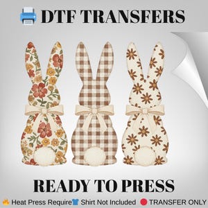 May include: DTF Transfers showing three Easter bunny designs. The bunnies have floral, gingham, and daisy patterns, with cream bows and fluffy white tails. The text "READY TO PRESS" is displayed below the bunnies.