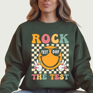 May include: A set of three ceramic mugs with a speckled, matte finish. The mugs are in shades of cream, light gray, and dark gray. Each mug has a simple, minimalist design, perfect for coffee or tea.