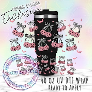 May include: Black 40 oz UV DTF wrap with a Halloween theme. The wrap features pink pumpkin cherries with black and white checkered bows, bats, and stars. The words "Original Designer Exclusive" are at the top.