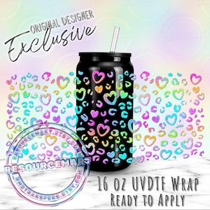 May include: Black 16 oz UVDTF wrap with a rainbow heart and leopard print design. The tumbler has a straw and the text "Original Designer Exclusive" is at the top. The words "Ready to Apply" are at the bottom.