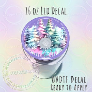 May include: A clear tumbler with a lid featuring a winter forest design. The lid has a purple border and a central design of colorful trees and snowflakes. Text on the lid reads "16 OZ LID DECAL". The words "UVDTF DECAL READY TO APPLY" are also visible.