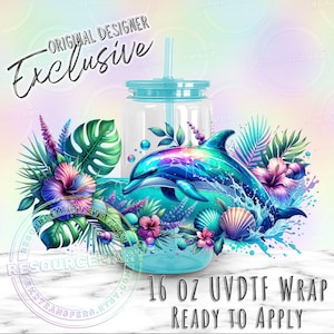 May include: A clear 16 oz tumbler with a turquoise lid and straw, featuring a vibrant dolphin design with tropical flowers and foliage. The words "Original Designer Exclusive" and "Ready to Apply" are also visible.
