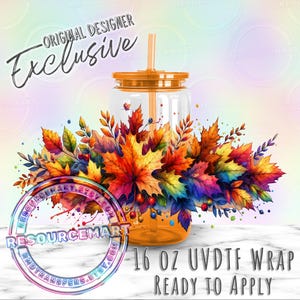 May include: A clear 16 oz tumbler with an orange lid and straw, adorned with a vibrant watercolor design of autumn leaves in shades of red, orange, yellow, and purple. The text "Original Designer Exclusive" and "16 OZ UVDTF WRAP READY TO APPLY" are visible.