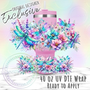 May include: A pink 40 oz tumbler wrap with a floral and dragonfly design. The wrap features colorful dragonflies and flowers in shades of blue, teal, pink, and purple. Text on the wrap reads "ORIGINAL DESIGNER Exclusive" and "40 OZ UV DTF WRAP READY TO APPLY."