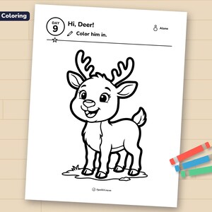 Day 9 reindeer coloring page printed on a sheet of paper, lying on a wooden table with three crayons.