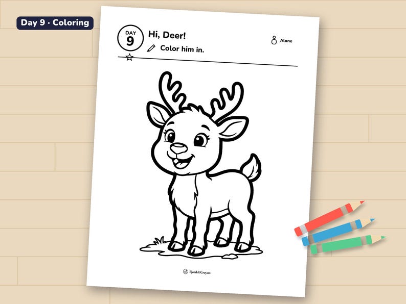 Day 9 reindeer coloring page printed on a sheet of paper, lying on a wooden table with three crayons.