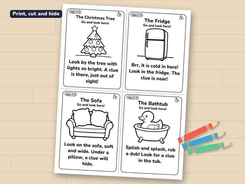 A sheet of four clue cards (Christmas tree, fridge, sofa, bathtub) printed and lying on a wooden table with three crayons.