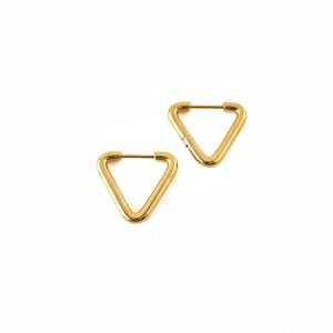 May include: A pair of gold-colored, triangular hoop earrings. The earrings are a simple geometric design, with a hinged closure. The earrings are set against a white background.