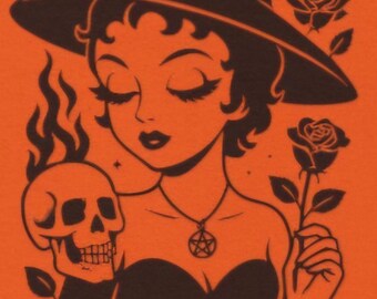 May include: A black graphic print on an orange background featuring a character wearing a pointed witch hat, a pentagram necklace, and a strapless top. The character holds a flaming skull and a single rose, with a crescent moon and stars above.