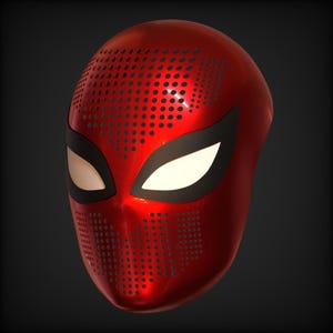 May include: A glossy red mask with black eye surrounds and white eye lenses. The mask has a perforated design on the forehead and mouth area. The mask is a superhero-themed item.