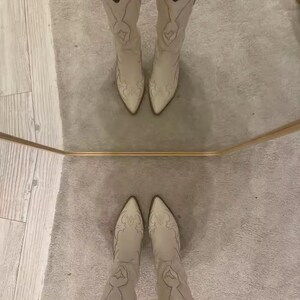 Step into the season with the ultimate statement piece. Our White Vintage Western Boots blend the rugged spirit of the frontier with high-fashion elegance. Featuring intricate tonal embroidery and a sophisticated pointed toe, these knee-high boots are designed to turn heads at weddings, festivals, or on a casual autumn stroll.