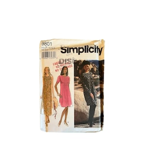May include: A Simplicity sewing pattern envelope labelled 9801, size P 12, 14, 16. The front displays illustrations of three dress variations: a long floral dress, a short pink dress, and a long-sleeved dark patterned dress, with text.