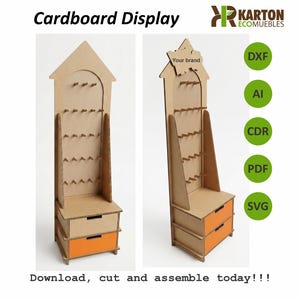 May include: A cardboard display unit with a house-shaped top, multiple shelves, and two orange drawers. The text "Cardboard Display" and "Download, cut and assemble today!!!" are visible. The display is designed for retail product presentation.