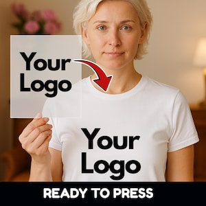 May include: White t-shirt with the text "Your Logo" printed in black. A transparent square with the same text is held up to the shirt, connected by a red arrow. The words "READY TO PRESS" are printed in white on a black background.